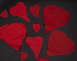 broken red valentine hearts on a black background, for february valentine's day celebration photo