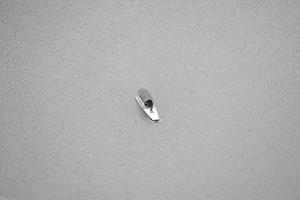 photo of a boat in the middle of a lake during the day