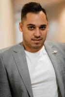 portrait of the groom in a light gray suit photo