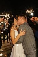 newlyweds at a wedding of sparklers photo