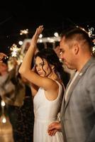 newlyweds at a wedding of sparklers photo