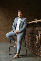 portrait of the groom in a light gray suit photo