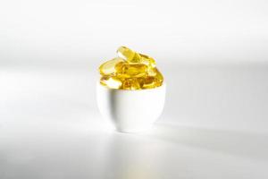 Food supplement oil filled fish oil, vitamin D, omega 3, omega 6, vitamin A, vitamin E, flaxseed oil. photo