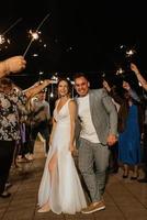 newlyweds at a wedding of sparklers photo