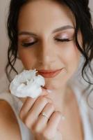 preparations for the bride with the dressing of the wedding dress photo