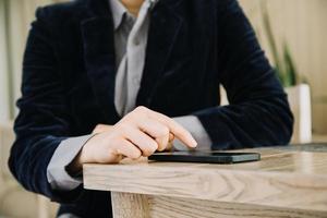 Mature businessman using a digital tablet to discuss information with a younger colleague in a modern business lounge photo