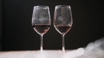 Set of hands holding red wine glass isolated on black background. photo