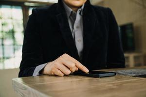 Mature businessman using a digital tablet to discuss information with a younger colleague in a modern business lounge photo
