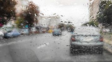 Front car window covered with rain drops video