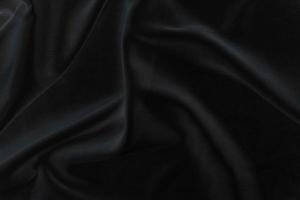 tela de seda negra elegante y suave o textura de tela satinada de lujo para un fondo abstracto foto