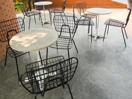 The modern metal chair with the small white table. photo