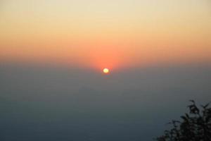 Beautiful scenery of the sunrise and sun from Pha Nok Aen cliff of Phu kradueng national park, Thailand. photo