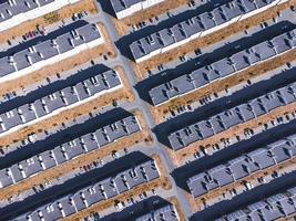 Top down view of low-rise residential buildings, lawns, roads and parking lots. photo