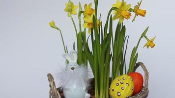 Bouquet of daffodils, Easter eggs and a rabbit. Minimal concept. copy space photo