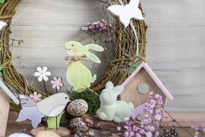 Easter background with Easter wreath and colored Easter eggs and blooming flowers. Easter composition. Easter. copy space photo