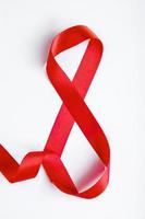 Number 8 from red silk ribbon on a white background. International women's day symbol. Spring holiday on March 8. photo