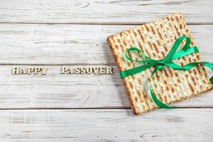 Happy Passover. Matzah on a white wooden background. Traditional Jewish regilious holiday of Pesach. Matzo bread. photo