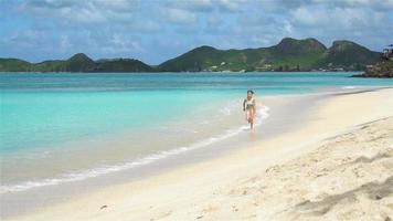 adorable petite fille sur la plage sur l'île des caraïbes. video