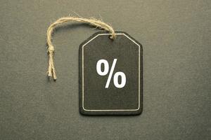 percent sign on the black price tag, black mockup background photo
