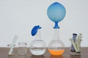 Student do science experiment, lab lesson, transparent bottles with inflated balloons on top of bottle. The experiment about air or gas reaction by using chemical substances. Education Science subject photo