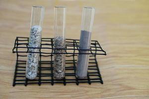 Test glass tubes that contain sample of different soil. Concept, soil quality inspection, research and science experiment. Laboratory. Find the best from different soil type and source photo