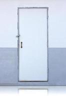 white wooden door on white and gray wall photo