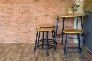 wood chair and table on brick wall photo