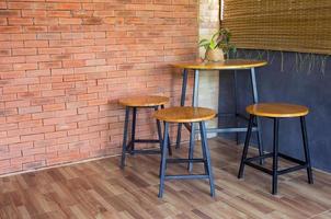 wood chair and table on brick wall photo