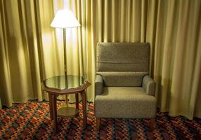 Sofa and lamp with table in the bedroom at night time photo