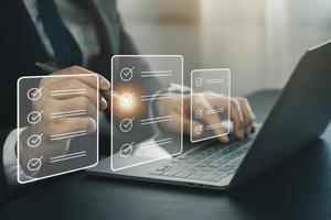 Electronic signature or checking list, Business man using pen checking digital virtual screen document, document management, paperless office, signing business contract, electronic document system. photo