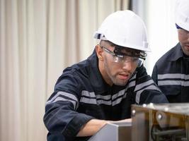 engineer male white hardhat safety uniform wear glasses manager labor staff factory look work job occupation maintenance industry motor gear steel technology construction technician architect facility photo