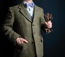 Portrait of Man in Tweed Suit Holding Brown Leather Gloves. Vintage Style and Retro Fashion of Classic English Gentleman. photo