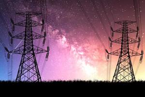 high voltage pylons at night There is a backdrop of the Milky Way and stars. photo