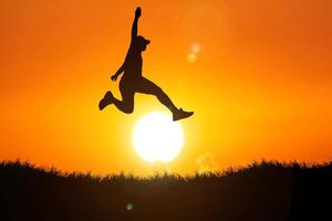 Silhouette of a man jumping. The concept of skipping, passing, moving forward. photo