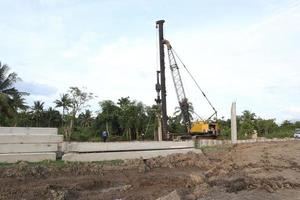 Gorontalo, Indonesia - January 2023 - Projects of river widening and the construction of dykes around the Limboto lake area photo