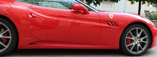 Sankt Petersburg Russia 10 15 2022  red Ferrari F12 berlinetta parked on a city street Perfect background for a text photo