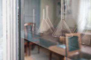 Funnel for a chemical laboratory on a cabinet shelf. photo