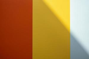 Background of red, yellow and gray colors with a shadow. Colored vertical stripes of different widths. Copy space. photo