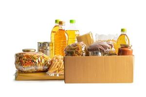 Foodstuff for donation, storage and delivery. Various food, pasta, cooking oil and canned food in cardboard box. photo