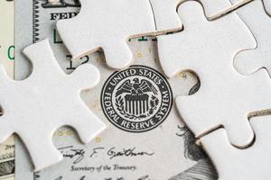 FED The Federal Reserve System with jigsaw puzzle paper, the central banking system of the United States of America. photo