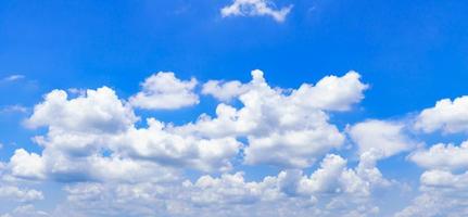 The sky is bright blue with beautiful fluffy clouds. blue sky with clouds photo