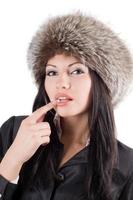 Portrait of the young woman in a fur cap. Isolated on white photo