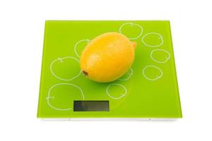 Yellow lemon on square scales photo