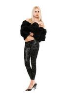 Charming young blonde in black coat and leggings photo