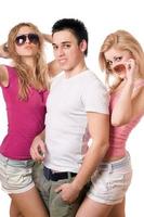 two playful blonde women with handsome young man photo