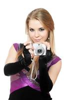 Attractive blonde holding a photo camera. Isolated