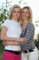 Portrait of two smiling beautiful young women photo