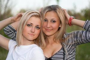 Closeup portrait of two attractive young women photo