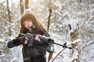 Brunette girl aiming a gun photo