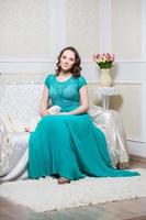 Beautiful woman in turquoise dress photo